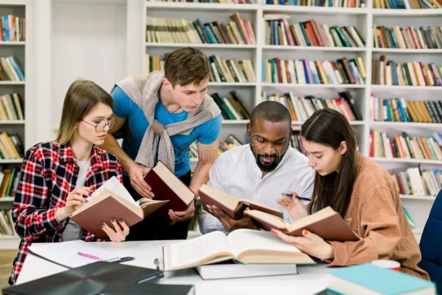 smart-confident-young-multiethnical-students-reading-books-table-looking-information-study-together-college-library-176807482